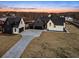 Aerial view of a modern farmhouse with attached garage and paved driveway at 5180 Howard Rd, Cumming, GA 30040