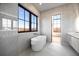 Luxurious bathroom with marble tile and a freestanding tub at 5180 Howard Rd, Cumming, GA 30040