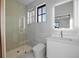 Modern bathroom with a glass shower, marble tile, and floating vanity at 5180 Howard Rd, Cumming, GA 30040