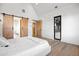 Bright bedroom with light wood floors and barn doors at 5180 Howard Rd, Cumming, GA 30040