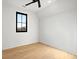 Light filled bedroom with hardwood floors and large window at 5180 Howard Rd, Cumming, GA 30040