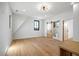 Bright bedroom featuring wood floors, white walls, and a sliding barn door to the bathroom at 5180 Howard Rd, Cumming, GA 30040