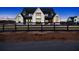 Farmhouse exterior at dusk with black metal roof and large windows at 5180 Howard Rd, Cumming, GA 30040