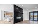 Modern living room with a black marble fireplace and pool view at 5180 Howard Rd, Cumming, GA 30040