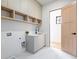 Modern laundry room with gray cabinetry and quartz countertop at 5180 Howard Rd, Cumming, GA 30040