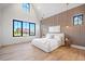 Spacious main bedroom with high ceiling, large windows, and wood accent wall at 5180 Howard Rd, Cumming, GA 30040