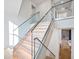 Modern staircase with glass railings and LED lighting at 5180 Howard Rd, Cumming, GA 30040