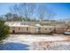Back exterior view of brick home and yard with mature trees in winter at 3002 Arabian Woods Dr, Lithonia, GA 30038