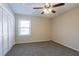 Cozy bedroom featuring gray carpet, a ceiling fan, natural light, and a closet at 3002 Arabian Woods Dr, Lithonia, GA 30038