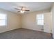 Bright bedroom with neutral walls, carpet floors, ceiling fan, and window with natural light at 3002 Arabian Woods Dr, Lithonia, GA 30038