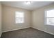 Carpeted bedroom features two windows that provide lots of natural light at 3002 Arabian Woods Dr, Lithonia, GA 30038