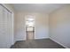 Bedroom area boasts neutral carpet and a view into the well-lit kitchen at 3002 Arabian Woods Dr, Lithonia, GA 30038