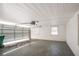 Spacious two car garage featuring an automatic door opener and single hung windows at 3002 Arabian Woods Dr, Lithonia, GA 30038