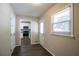 Hallway that opens up to a view of the kitchen, filled with stainless steel appliances at 3002 Arabian Woods Dr, Lithonia, GA 30038