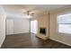 Bright living room with a fireplace, large window, and sleek wood flooring at 3002 Arabian Woods Dr, Lithonia, GA 30038