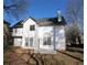 Backyard view of the two-story traditional home featuring a patio area, a chimney, and a manicured lawn at 4259 Creek Haven Dr, Marietta, GA 30062