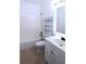 Clean bathroom with a tub, toilet, and vanity with sink and storage, plus shelf rack at 4259 Creek Haven Dr, Marietta, GA 30062