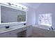 Bright bathroom with double vanity, soaking tub, and large, lit mirror at 4259 Creek Haven Dr, Marietta, GA 30062
