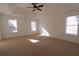 Spacious bedroom with a ceiling fan and three large windows for ample natural light at 4259 Creek Haven Dr, Marietta, GA 30062