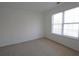 A well-lit bedroom featuring a neutral carpet and a large window with blinds at 4259 Creek Haven Dr, Marietta, GA 30062
