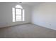 Bedroom featuring neutral carpet, white walls, and a large window with a view at 4259 Creek Haven Dr, Marietta, GA 30062