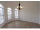 Bright dining room featuring wood flooring, arched windows, decorative wainscoting, and chandelier at 4259 Creek Haven Dr, Marietta, GA 30062