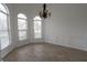 Dining room featuring three large arched windows, wood flooring, and decorative trim at 4259 Creek Haven Dr, Marietta, GA 30062