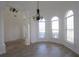 Bright dining room featuring wood flooring, arched windows, decorative wainscoting, and chandelier at 4259 Creek Haven Dr, Marietta, GA 30062