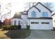 Charming two-story stucco home with a two-car garage, arched windows, and well-maintained landscaping at 4259 Creek Haven Dr, Marietta, GA 30062