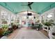 Bright sunroom with abundant plants and seating area at 5839 Darry Cir, Norcross, GA 30093