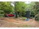 Side view of house with a red truck parked on a driveway at 6637 Victory Dr, Acworth, GA 30102