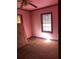 Pink walls, wood floors, and a mattress in this small bedroom at 1722 Donnalee Ave, Atlanta, GA 30016