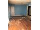 A living room with blue walls and hardwood floors needing repair at 1722 Donnalee Ave, Atlanta, GA 30016