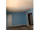 A living room with blue walls and hardwood floors needing repair at 1722 Donnalee Ave, Atlanta, GA 30016