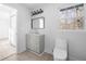 Simple bathroom with gray vanity and toilet at 2301 Troy Cove Rd, Decatur, GA 30035