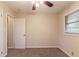 Neutral bedroom featuring a window, plush carpet, neutral paint, and a ceiling fan at 2405 County Line Sw Rd, Atlanta, GA 30331