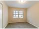 Neutral bedroom featuring one window with blinds, plush carpet, and neutral paint at 2405 County Line Sw Rd, Atlanta, GA 30331