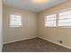 Neutral bedroom featuring two windows with blinds, plush carpet, and neutral paint at 2405 County Line Sw Rd, Atlanta, GA 30331