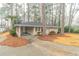 View of cozy single-story home featuring a convenient carport and extended driveway amid lush surroundings at 2405 County Line Sw Rd, Atlanta, GA 30331