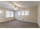 Inviting living room with neutral carpet, ceiling fan and multiple windows offering abundant natural light at 2405 County Line Sw Rd, Atlanta, GA 30331