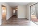 Open floor plan showcasing laminate wood flooring, and a kitchen view, filled with natural light at 2405 County Line Sw Rd, Atlanta, GA 30331