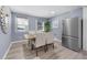 Bright dining area adjacent to the kitchen features a modern dining set and stainless-steel refrigerator at 2529 Dale Creek Nw Dr, Atlanta, GA 30318