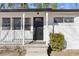 Charming front porch with black door and white railings at 2529 Dale Creek Nw Dr, Atlanta, GA 30318