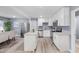 Open-concept kitchen with white cabinetry, stainless steel appliances, and a dining area at 2529 Dale Creek Nw Dr, Atlanta, GA 30318