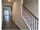 Two-story foyer with dark hardwood floors and black iron staircase at 6615 Bluffview Dr, Douglasville, GA 30134