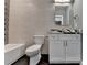 Basement bathroom with white vanity, textured wall tile, and hexagon floor tile at 6770 Cadence Blvd, Atlanta, GA 30328