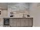 Basement wet bar with gray cabinets and quartz countertop at 6770 Cadence Blvd, Atlanta, GA 30328