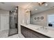 Double vanity bathroom with a large mirror and a glass shower at 6770 Cadence Blvd, Atlanta, GA 30328