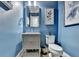 Modern powder room with gray vanity and blue walls at 6770 Cadence Blvd, Atlanta, GA 30328