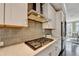 Kitchen with gas cooktop and gray tile backsplash at 6770 Cadence Blvd, Atlanta, GA 30328